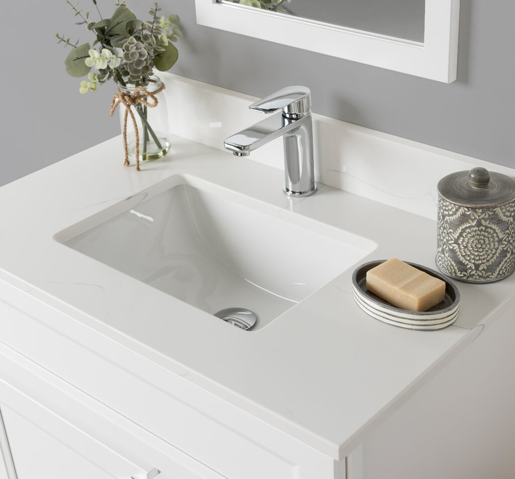 A white bathroom vanity with a sink and mirror.