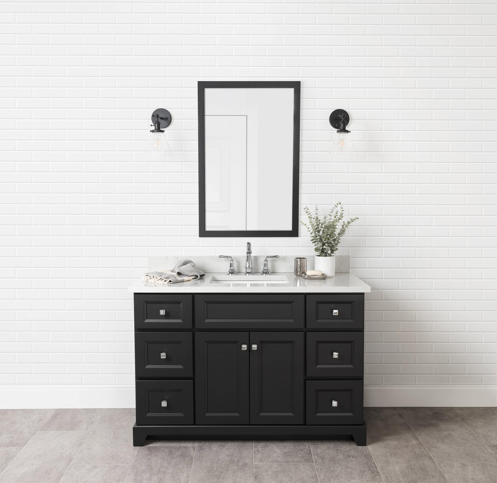 48" Midnight vanity with bellrose doors and shale quartz countertop against a white subway tile wall, featuring a large framed mirror and wall-mounted lights.